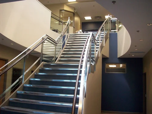 Stainless steel handrails with glass infill in a finished interior