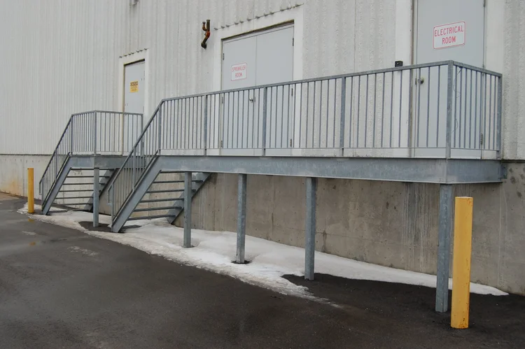 Galvanized exterior access platform, stairs and railings with protective bollards