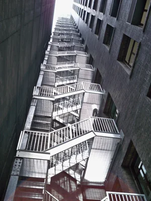 Galvanized multi-story exterior stair tower with grating treads